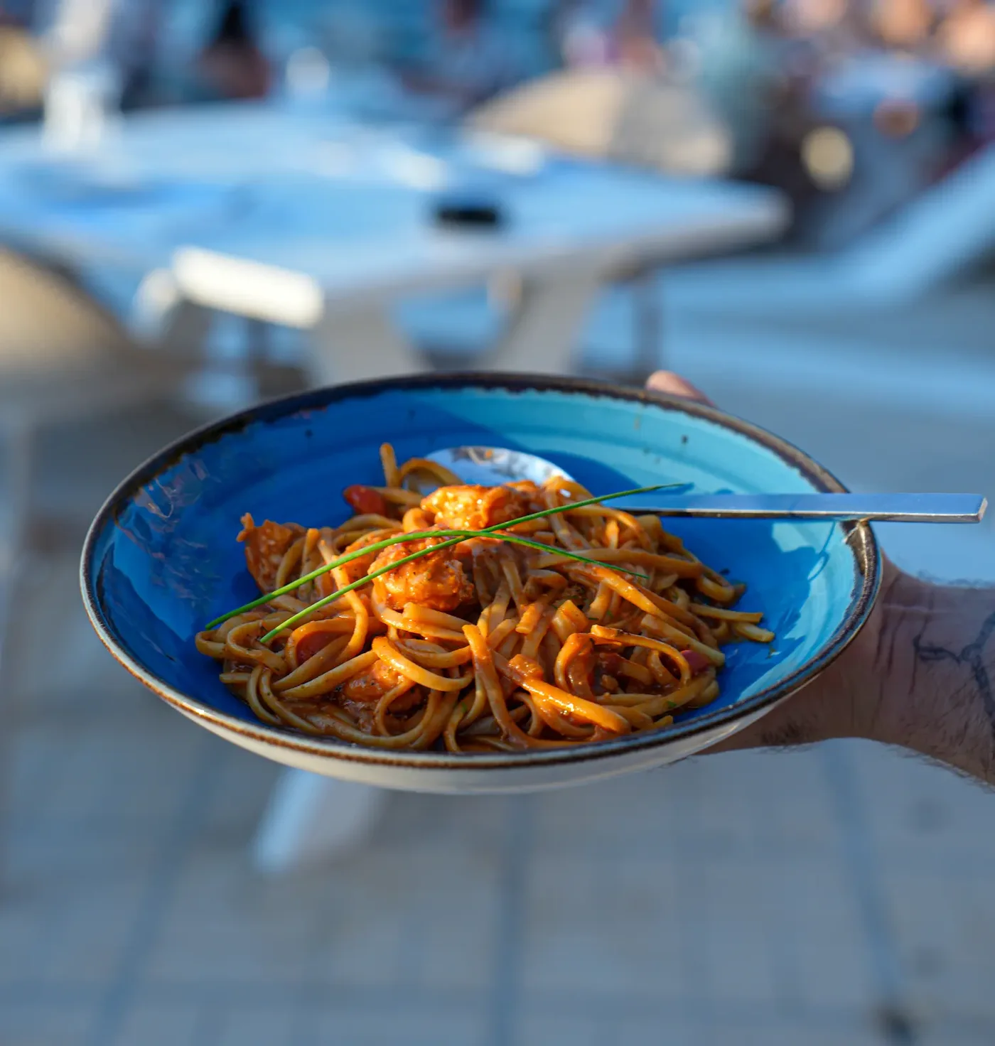 Fresh pasta served on a blue plate